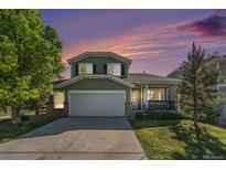 Charming two-story home with a well-manicured lawn, mature trees, and a two-car garage at 5405 Military Trl, Parker, CO 80134
