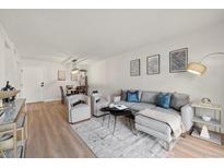Bright living room features contemporary furnishings, stylish decor, and hardwood flooring at 7770 W 38Th Ave # 108, Wheat Ridge, CO 80033