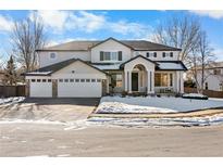 Two-story home with three-car garage and landscaped front yard at 806 Ridgemont Cir, Highlands Ranch, CO 80126