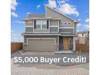 Beautiful two-story home with a two-car garage and modern architectural details at 10011 Yampa Ct, Commerce City, CO 80022