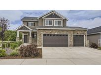 Beautiful two-story home featuring a three-car garage and stone accents at 4433 N Picadilly Ct, Aurora, CO 80019
