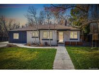 Charming single story home featuring a freshly manicured lawn and inviting front porch at 7320 W 21St Ave, Lakewood, CO 80214