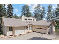 Charming single-Gathering home with a two-car garage and a well-maintained lawn surrounded by mature trees at 649 Cottonwood Dr, Evergreen, CO 80439