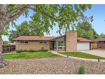 Charming single-story home with brick facade, manicured lawn, and a welcoming entrance at 7491 W 45Th Ave, Wheat Ridge, CO 80033