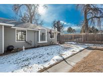 Ranch style home with gray siding, landscaped yard, and walkway at 7933 York St # 1, Denver, CO 80229