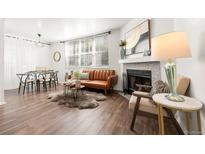 Bright living room featuring a fireplace, wood floors, and comfortable seating at 5745 W Atlantic Pl # 108, Lakewood, CO 80227