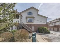 Inviting townhome featuring well-maintained landscaping, stairs to unit entry, and convenient parking at 3010 W Prentice Ave # J, Littleton, CO 80123