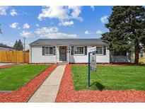 Charming home with a freshly manicured lawn and a welcoming walkway to the front door at 925 Fulton St, Aurora, CO 80010