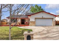 Charming ranch-style home featuring a well-manicured lawn and a spacious two-car garage at 12079 E Louisiana Ave, Aurora, CO 80012