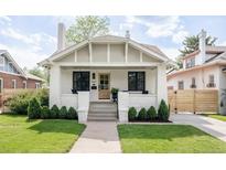 Charming home featuring a brick facade, covered porch, and well-manicured lawn at 4261 Julian St, Denver, CO 80211