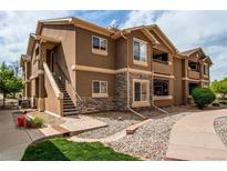 Attractive condo featuring stone accents, private entrances, and well-maintained landscaping at 4730 Copeland Cir # 204, Highlands Ranch, CO 80126