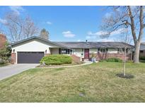 Charming single-story home with brick accents, a well-maintained lawn, and an attached two-car garage at 4152 S Vrain St, Denver, CO 80236