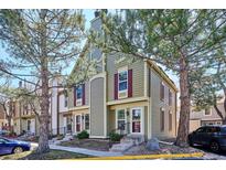 Charming townhome showcasing an inviting exterior with neutral siding and red shutters at 1811 S Quebec Way # 221, Denver, CO 80231