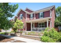 Charming two-story home featuring a welcoming front porch, complemented by a beautifully landscaped yard at 2746 Geneva St, Denver, CO 80238