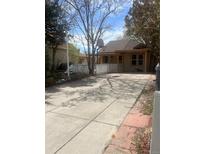 Charming bungalow-style home with a spacious driveway, inviting porch, and classic curb appeal at 325 N 7Th Ave, Brighton, CO 80601