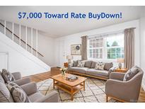 Inviting living room showcasing hardwood floors and plenty of natural light from the large window at 2856 Jasmine St, Denver, CO 80207