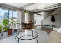 Cozy living area with a large glass table and ample natural light, creating an inviting atmosphere at 9605 E Kansas Cir # 55, Denver, CO 80247
