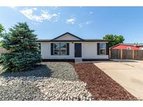 Charming single-story home with neutral siding, black accents, landscaping, and a well-maintained front yard at 657 Locust Ave, Lochbuie, CO 80603