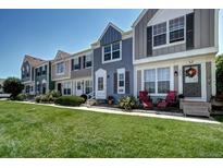 Attractive townhomes with well-manicured front lawn, colorful facades, and inviting entrances at 19804 Summerset Ln, Parker, CO 80138