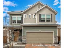 Charming two-story home featuring a two-car garage, stone accents, and beautifully coordinated siding under a partly cloudy sky at 10125 Zeno St, Commerce City, CO 80022