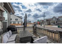 Inviting porch with comfortable seating area, offering a relaxing outdoor space at 688 N Bersshine Ct, Watkins, CO 80137