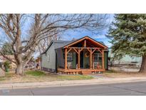 Charming home featuring a covered front porch with wood beam accents and ample outdoor seating at 329 2Nd St, Frederick, CO 80530
