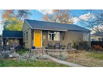 Cute bungalow home with yellow door and landscaping at 2643 S Cook St, Denver, CO 80210