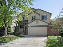 Charming two-story home with a well-maintained lawn and a two-car garage at 1250 S Boyero Ct, Superior, CO 80027