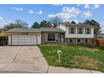 Charming two-story home with a well-maintained front yard and attached two-car garage in a residential neighborhood at 16533 E Baker Pl, Aurora, CO 80013