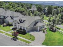 Stunning home featuring lush landscaping, a circular driveway, and an attached three-car garage at 14075 Turnberry Ct, Broomfield, CO 80023