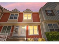 Charming two-story townhome with colorful siding and well-manicured landscaping at 6776 S Independence St, Littleton, CO 80128
