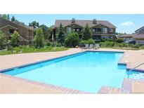 Inviting community pool surrounded by lounge chairs and well-maintained landscaping at 4680 Copeland Loop # 203, Highlands Ranch, CO 80126