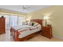 Cozy bedroom with wood furniture, ceiling fan, and natural light, perfect for relaxation at 800 N Washington St # 307, Denver, CO 80203
