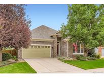 Charming stone home with a manicured lawn and mature trees offers great curb appeal at 12164 Adams St, Thornton, CO 80241