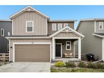 Charming two-story home featuring a covered porch, attached garage, and neutral-toned siding at 545 High Point Dr, Longmont, CO 80504