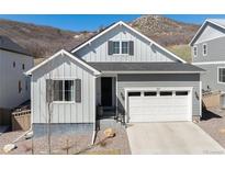 Charming single-Gathering home featuring a white garage door and a manicured, minimalist front yard at 865 Oleander St, Castle Rock, CO 80109