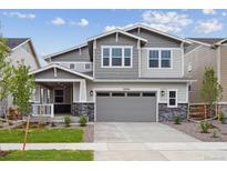 Charming two-story home with gray siding, stone accents, and a well-manicured front yard at 24768 E 40Th Ave, Aurora, CO 80019