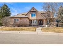 Inviting home with a well-manicured lawn, beautiful landscaping and a neutral color palette at 7035 S Picadilly St, Aurora, CO 80016
