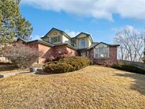 Brick two-story house with landscaping and a large yard at 2694 S Fenton Ct, Lakewood, CO 80227