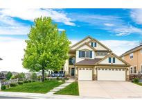 Charming two-story home features a three-car garage and inviting front porch at 22962 Briar Leaf Ave, Parker, CO 80138