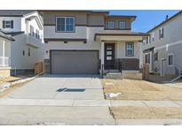 Two-story home with attached garage and landscaping at 9208 Truckee Ct, Commerce City, CO 80022