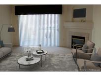 Bright living room featuring a fireplace, modern furniture, and a large sliding door with vertical blinds at 3220 Boulder Cir # 103, Broomfield, CO 80023