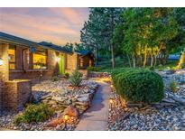 Charming walkway with stone accents leads to the inviting home with a vibrant green door at 19 Rock Ln, Castle Rock, CO 80104