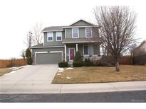 Two-story house with attached garage and landscaped yard at 6297 Clayton Cir, Frederick, CO 80530