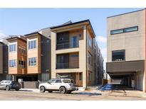 Modern three-story townhome with wood siding and a sleek design at 4455 Tennyson St, Denver, CO 80212