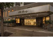 The Barclay building features stone accents, manicured landscaping, and covered entrance at 1625 Larimer St # 605, Denver, CO 80202