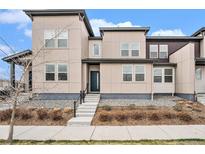 Well maintained home with a modern exterior, featuring neutral siding, concrete steps, and stone landscaping at 4755 Memphis St # 2, Denver, CO 80239
