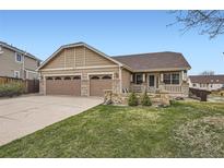 Charming single-Gathering home featuring a three-car garage and a well-maintained front lawn at 6079 W Prentice Ave, Littleton, CO 80123