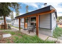 Charming home with a covered porch, rustic wood accents, and inviting curb appeal at 32 Magnum Bonum Dr, Breckenridge, CO 80424