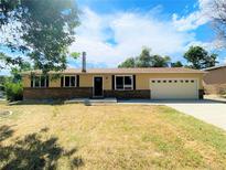 Charming single-story home with a brick facade and attached two-car garage at 4559 Ashfield Dr, Boulder, CO 80301